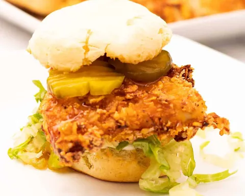 Fried chicken and biscuit sandwich with mayo, shredded lettuce, pickles, and hot honey sauce.