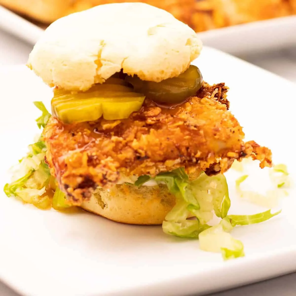 Fried chicken and biscuit sandwich with mayo, shredded lettuce, pickles, and hot honey sauce.